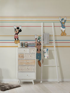 mickey mouse wall decals in a child's room with stripes on the walls