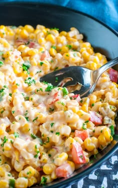 a skillet filled with macaroni and cheese, garnished with parsley