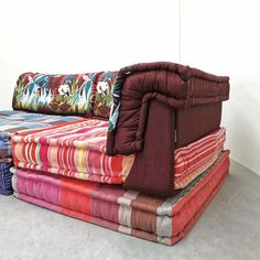 a group of colorful couches stacked on top of each other