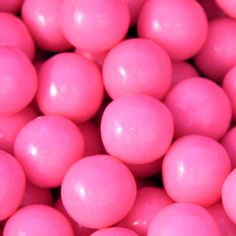 pink candy balls are shown close up