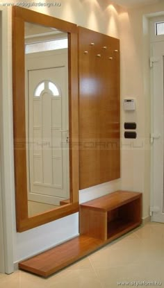 a large mirror sitting on top of a wooden cabinet next to a door and window