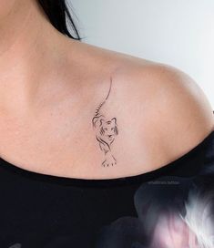 a woman with a tattoo on her shoulder