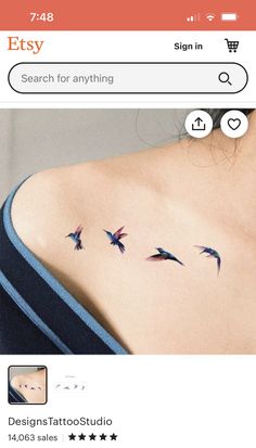 the back of a woman's shoulder with three birds on it and an arrow in the middle