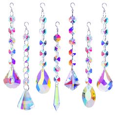 several different colors of crystal hanging from hooks