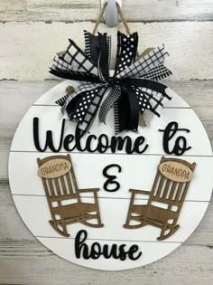 a welcome sign with two rocking chairs on it