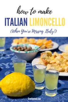 a table topped with plates and glasses filled with lemonade next to a bowl of olives