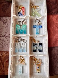 an ice tray filled with different types of key chains