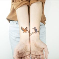 two people with matching tattoos on their arms