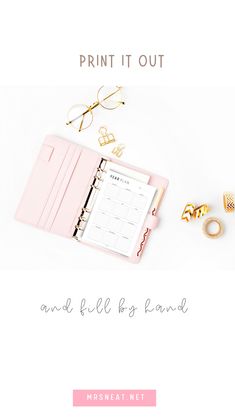 a pink binder with gold rings and eyeglasses on it next to a planner