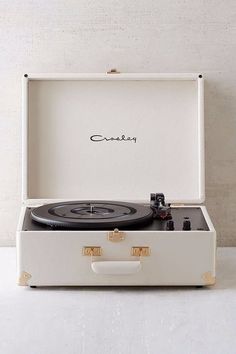 an old record player in a white suitcase