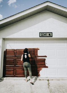 a woman standing in front of a garage door