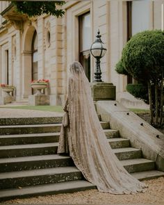 a woman in a wedding dress standing on some steps