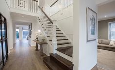 there is a staircase leading up to the second floor in this modern home with white walls and wood floors