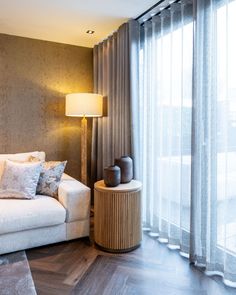 a white couch sitting next to a window in a living room