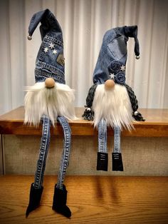 two gnomes made out of jeans are sitting on a shelf