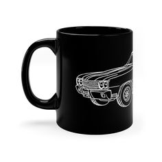 a black coffee mug with a drawing of a car on the front and back sides