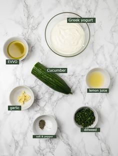 ingredients to make cucumber salad laid out on a marble counter top