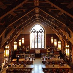 the inside of a large library with tables and bookshelves filled with lots of books