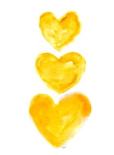 three yellow hearts are arranged in the shape of a heart on a white paper background