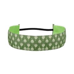 a green headband with white dots on it