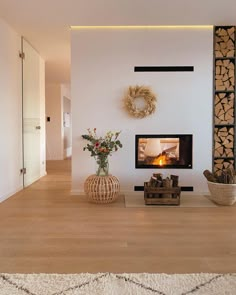 a living room filled with furniture and a fire place next to a wall mounted tv