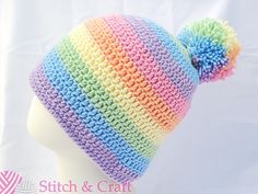 a multicolored knitted hat on top of a mannequin head