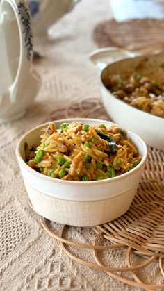 a bowl filled with rice and peas on top of a table next to other dishes