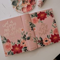 an open pink notebook with flowers on it