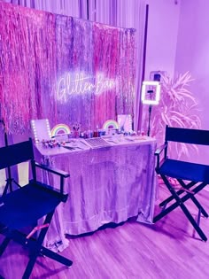 a table set up with two chairs and a sign that says glitter bar on it