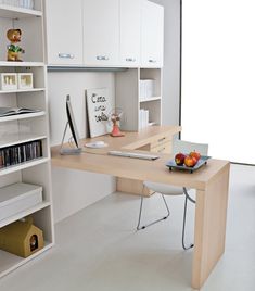 a desk with books and fruit on it in front of a book shelf filled with books