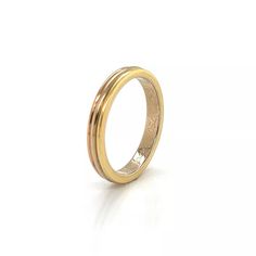 a gold wedding ring on a white background