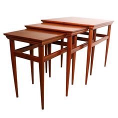 three wooden tables sitting next to each other