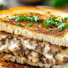 a grilled cheeseburger with mushrooms and gravy on toasted bread