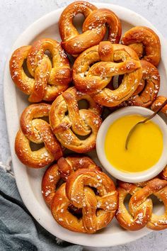 pretzels on a plate with dipping sauce