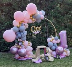 an outdoor birthday party with balloons and decorations