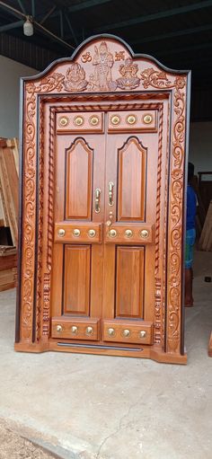 a wooden door with intricate carvings on the front and side doors are made from wood