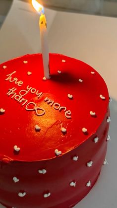 a red heart shaped cake with a single candle on top that says, one you love what's more