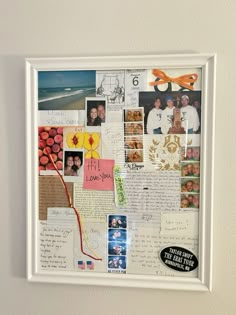 a collage of photos and letters is displayed on a white framed wall with scissors