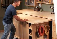 a man standing in front of a workbench