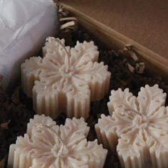 four white soaps sitting in a box