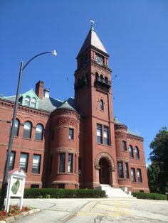 an old red brick building with a clock tower