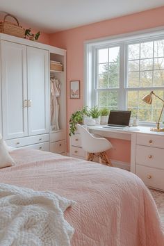 a bedroom with pink walls, white furniture and a large window that overlooks the trees