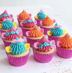 cupcakes decorated with colorful frosting and decorations