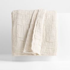 a white blanket folded on top of a table