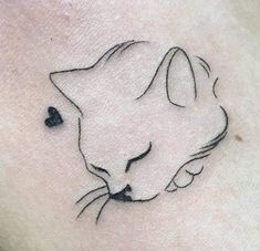 a black and white cat tattoo on the chest