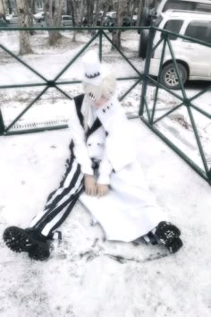 a person sitting on the ground in the snow