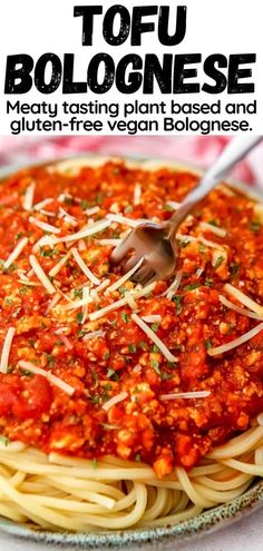 a plate of spaghetti with sauce and cheese on top, in front of the words tofu bologinese