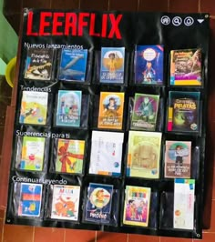 a bunch of books that are sitting on a table in front of a sign with the words leerflix