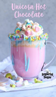 there is a drink with marshmallows and unicorn toppings in it on the table