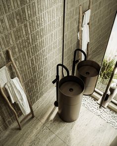 two buckets sitting next to each other in a bathroom